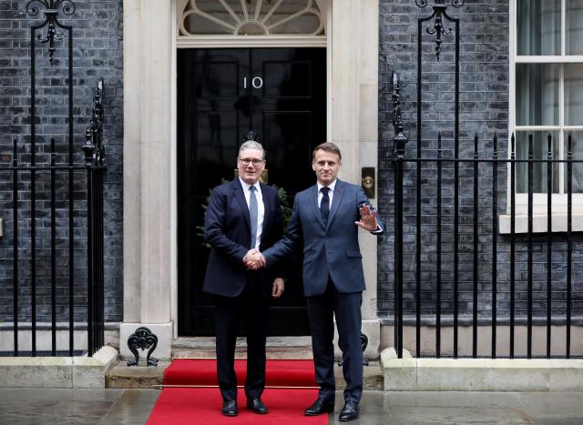 (251208) -- LONDON, Dec. 8, 2025 (Xinhua) -- British Prime Minister Keir Starmer (L) shakes hands with French President Emmanuel Macron prior to a meeting between the leaders of Britain, France, Germany and Ukraine at 10 Downing Street in London, Britain, Dec. 8, 2025. (Xinhua/Li Ying)