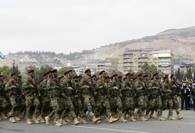 (251208) -- DAMASCUS, Dec. 8, 2025 (Xinhua) -- Syrian soldiers march during a military parade marking the first anniversary of Syria's political transition in Damascus, Syria, Dec. 8, 2025. Syria's interim authorities staged a major military parade in the capital, Damascus, on Monday to mark the first anniversary of the country's political transition. (Photo by Ammar Safarjalani/Xinhua)