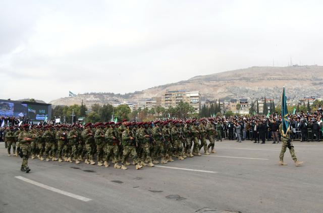 (251208) -- DAMASCUS, Dec. 8, 2025 (Xinhua) -- Syrian soldiers march during a military parade marking the first anniversary of Syria's political transition in Damascus, Syria, Dec. 8, 2025. Syria's interim authorities staged a major military parade in the capital, Damascus, on Monday to mark the first anniversary of the country's political transition. (Photo by Ammar Safarjalani/Xinhua)