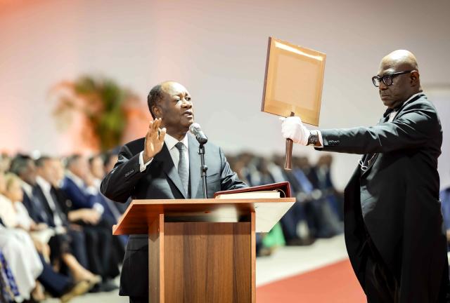 (251208) -- ABIDJAN, Dec. 8, 2025 (Xinhua) -- Incumbent President Alassane Ouattara (L) is sworn in for a new term in Abidjan, economic capital of Cote d'Ivoire, Dec. 8, 2025. Alassane Ouattara, incumbent President of Cote d'Ivoire, was sworn in before the Constitutional Council on Monday, for a fourth five-year term, after winning the election with 89.77 percent of the votes. (Photo by Yvan Sonh/Xinhua)