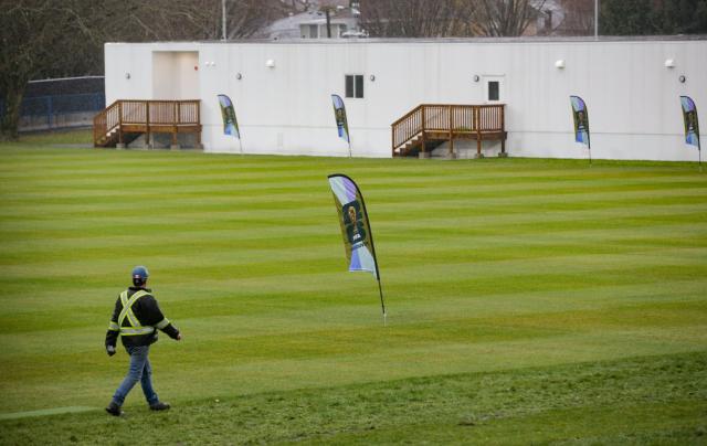 (251209) -- VANCOUVER, Dec. 9, 2025 (Xinhua) -- A worker walks past the pitch at the training site for the FIFA World Cup 2026 in Vancouver, British Columbia, Canada, on Dec. 8, 2025. Members of the media visited the Venue Specific Training Site (VSTS) at Killarney Park on Monday, the primary training facility for FIFA World Cup 2026 teams in Vancouver. The tour provided an overview of the upgraded pitch, athlete amenities, and site preparations meeting FIFA standards. (Photo by Liang Sen/Xinhua)