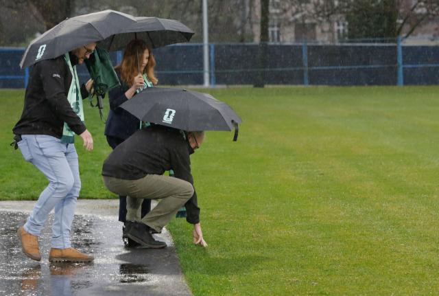 (251209) -- VANCOUVER, Dec. 9, 2025 (Xinhua) -- People examine the pitch grass during a media event at the training site for the FIFA World Cup 2026 in Vancouver, British Columbia, Canada, on Dec. 8, 2025. Members of the media visited the Venue Specific Training Site (VSTS) at Killarney Park on Monday, the primary training facility for FIFA World Cup 2026 teams in Vancouver. The tour provided an overview of the upgraded pitch, athlete amenities, and site preparations meeting FIFA standards. (Photo by Liang Sen/Xinhua)