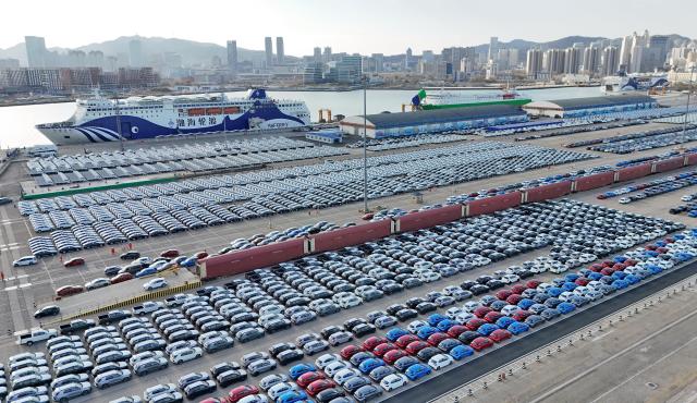 (251209) -- BEIJING, Dec. 9, 2025 (Xinhua) -- An aerial drone photo taken on Dec. 8, 2025 shows domestically produced vehicles for export at Yantai Port in east China's Shandong Province. (Photo by Tang Ke/Xinhua)