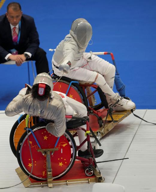 (251209) -- HONG KONG, Dec. 9, 2025 (Xinhua) -- Tian Jianquan (back) of Jiangsu and Li Hao of Shanghai compete during the Men's Sabre Individual category A final of Wheelchair Fencing event at China's 12th National Games for Persons with Disabilities and the 9th National Special Olympic Games in Hong Kong, south China, Dec. 9, 2025. (Xinhua/Hou Zhaokang)
