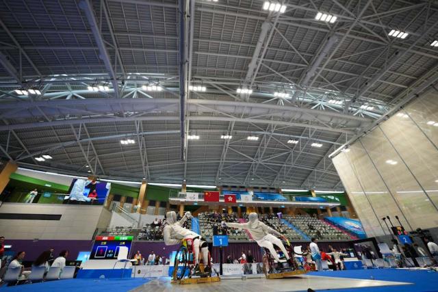 (251209) -- HONG KONG, Dec. 9, 2025 (Xinhua) -- Cheng Yang (L) of Jiangsu and Wang Jianqiang of Shanghai compete during the Men's Sabre Individual category A quarterfinals of Wheelchair Fencing event at China's 12th National Games for Persons with Disabilities and the 9th National Special Olympic Games in Hong Kong, south China, Dec. 9, 2025. (Xinhua/Hou Zhaokang)