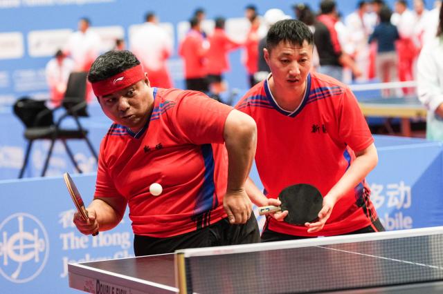 (251209) -- HONG KONG, Dec. 9, 2025 (Xinhua) -- Wang Wei/Liu Daopei (L) of Xinjiang compete during the men's doubles age 30+ group A match of special olympics table tennis at China's 12th National Games for Persons with Disabilities and the 9th National Special Olympic Games in Hong Kong, south China, Dec. 9, 2025. (Xinhua/Zhu Zheng)