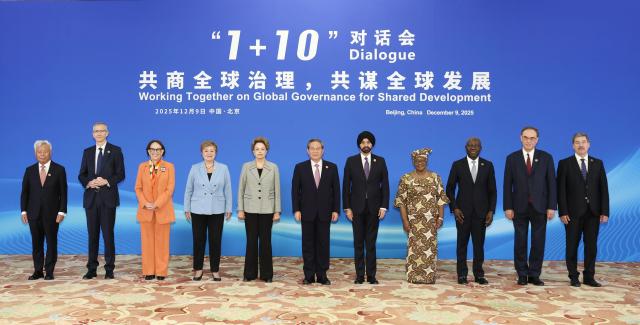 (251209) -- BEIJING, Dec. 9, 2025 (Xinhua) -- Chinese Premier Li Qiang holds the "1+10" Dialogue with heads of major international economic organizations at the Diaoyutai State Guesthouse in Beijing, capital of China, Dec. 9, 2025. The heads of major international economic organizations present at the dialogue were President of the New Development Bank Dilma Rousseff, President of the World Bank Ajay Banga, Managing Director of the International Monetary Fund Kristalina Georgieva, Director-General of the World Trade Organization Ngozi Okonjo-Iweala, Secretary-General of the UN Conference on Trade and Development Rebeca Grynspan, Director-General of the International Labour Organization Gilbert F. Houngbo, General Manager of the Bank for International Settlements Pablo Hernandez de Cos, Chair of the Financial Stability Board Andrew Bailey, President of the Asian Infrastructure Investment Bank Jin Liqun, and Deputy Secretary-General of the Organization for Economic Co-operation and Development Frantisek Ruzicka. (Xinhua/Huang Jingwen)