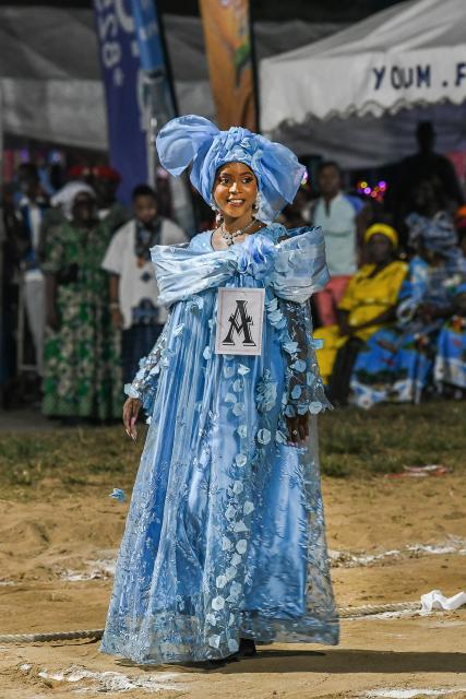 (251209) -- YAOUNDE, Dec. 9, 2025 (Xinhua) -- A "Miss Ngondo" contestant displays traditional dress of the Sawa people during the Ngondo Festival in Douala, Cameroon, on Dec. 5, 2025. Thousands recently gathered along the banks of the Wouri River in Cameroon's commercial hub, Douala, to witness the Ngondo Festival, as the Sawa community's iconic river ritual marked its first anniversary as a globally renowned intangible cultural heritage. (Xinhua/Kepseu)