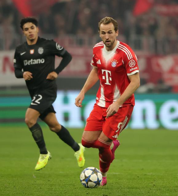 (251210) -- MUNICH, Dec. 10, 2025 (Xinhua) -- Harry Kane (R) of Bayern Munich competes during the UEFA Champions League football match between Bayern Munich and Sporting CP in Munich, Germany, Dec. 9, 2025. (Photo by Philippe Ruiz/Xinhua)
