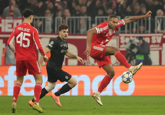 (251210) -- MUNICH, Dec. 10, 2025 (Xinhua) -- Jonathan Tah (R) of Bayern Munich vies with Georgios Vagiannidis (C) of Sporting CP during the UEFA Champions League football match between Bayern Munich and Sporting CP in Munich, Germany, Dec. 9, 2025. (Photo by Philippe Ruiz/Xinhua)