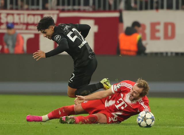 (251210) -- MUNICH, Dec. 10, 2025 (Xinhua) -- Harry Kane (bottom) of Bayern Munich vies with Joao Simoes of Sporting CP during the UEFA Champions League football match between Bayern Munich and Sporting CP in Munich, Germany, Dec. 9, 2025. (Photo by Philippe Ruiz/Xinhua)