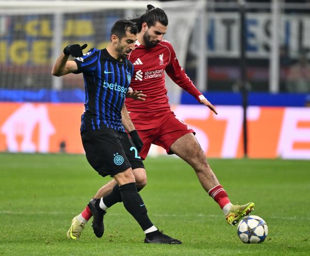 (251210) -- MILAN, Dec. 10, 2025 (Xinhua) -- Inter Milan's Henrikh Mkhitaryan (L) vies with Liverpool's Dominik Szoboszlai during the UEFA Champions League between Inter Milan and Liverpool in Milan, Italy, Dec. 9, 2025. (Photo by Alberto Lingria/Xinhua)