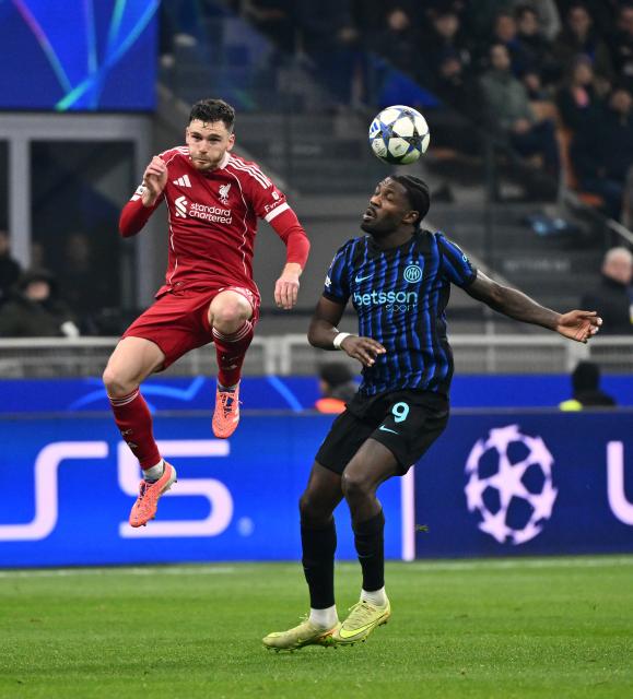 (251210) -- MILAN, Dec. 10, 2025 (Xinhua) -- Inter Milan's Marcus Thuram (R) vies with Liverpool's Andy Robertson during the UEFA Champions League between Inter Milan and Liverpool in Milan, Italy, Dec. 9, 2025. (Photo by Alberto Lingria/Xinhua)