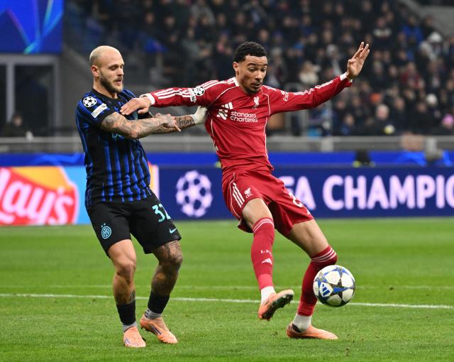 (251210) -- MILAN, Dec. 10, 2025 (Xinhua) -- Inter Milan's Federico Dimarco (L) vies with Liverpool's Hugo Ekitike during the UEFA Champions League between Inter Milan and Liverpool in Milan, Italy, Dec. 9, 2025. (Photo by Alberto Lingria/Xinhua)