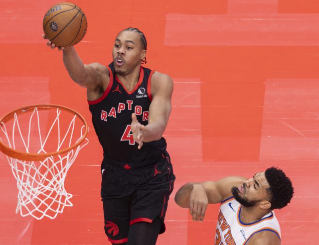 (251210) -- TORONTO, Dec. 10, 2025 (Xinhua) -- Scottie Barnes (L) of Toronto Raptors goes up for a layup during the 2025-2026 NBA Cup quarterfinal match between Toronto Raptors and New York Knicks in Toronto, Canada, on Dec. 9, 2025. (Photo by Zou Zheng/Xinhua)