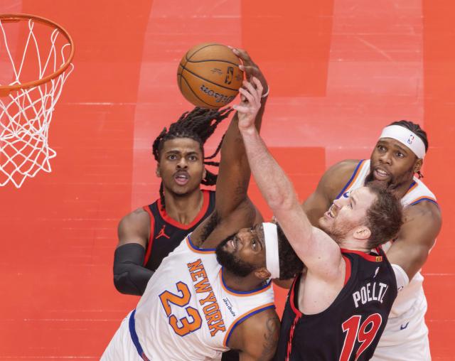(251210) -- TORONTO, Dec. 10, 2025 (Xinhua) -- Jakob Poeltl (front R) of Toronto Raptors fights for a rebound with Mitchell Robinson (front L) of New York Knicks during the 2025-2026 NBA Cup quarterfinal match between Toronto Raptors and New York Knicks in Toronto, Canada, on Dec. 9, 2025. (Photo by Zou Zheng/Xinhua)