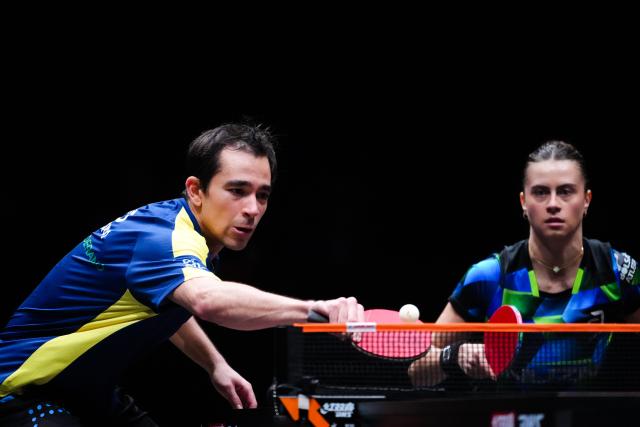 (251210) -- HONG KONG, Dec. 10, 2025 (Xinhua) -- Hugo Calderano (L)/Bruna Takahashi of Brazil compete during the mixed doubles group 2 match between Lim Jonghoon/Shin Yubin of South Korea and Hugo Calderano/Bruna Takahashi of Brazil of the WTT Finals Hong Kong 2025 in Hong Kong, south China, Dec. 10, 2025. (Xinhua/Zhu Wei)