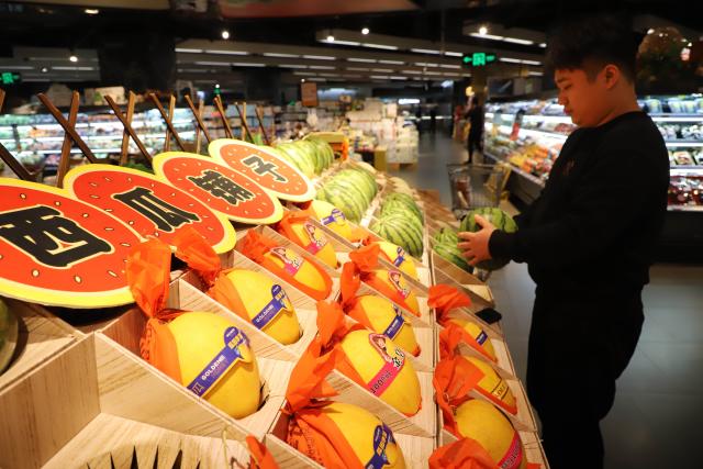(251210) -- BEIJING, Dec. 10, 2025 (Xinhua) -- A consumer selects fruit at a supermarket in Xiamen City, southeast China's Fujian Province, Dec. 10, 2025. China's consumer price index (CPI), a main gauge of inflation, rose 0.7 percent year on year in November, data from the National Bureau of Statistics showed Wednesday. (Photo by Zeng Demeng/Xinhua)
