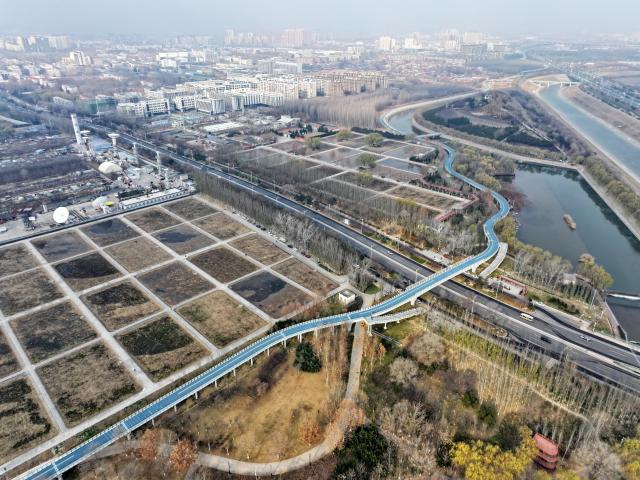 (251210) -- SHIJIAZHUANG, Dec. 10, 2025 (Xinhua) -- An aerial drone photo taken on Dec. 10, 2025 shows an urban ring greenway crossing a wetland park in Shijiazhuang, north China's Hebei Province. The 101-kilometer-long urban ring greenway in Shijiazhuang was made fully accessible to the public on Wednesday. The road facility links multiple waterways as well as 76 parks in the city, providing rich recreational experiences. (Xinhua/Mu Yu)