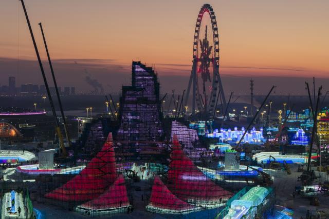 (251210) -- HARBIN, Dec. 10, 2025 (Xinhua) -- A drone photo taken on Dec. 10, 2025 shows the construction site of the main tower of the Harbin Ice and Snow World in Harbin, northeast China's Heilongjiang Province. The main tower of the 27th edition of Harbin Ice and Snow World was topped out on Wednesday, which costs 39,000 cubic meters of ice to build. (Xinhua/Zhang Tao)