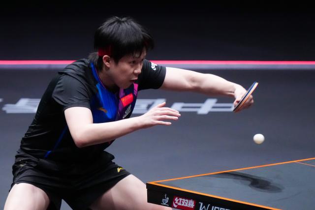 (251210) -- HONG KONG, Dec. 10, 2025 (Xinhua) -- Wang Chuqin hits a return during the men's singles round of 16 match between Wang Chuqin of China and Matsushima Sora of Japan at the WTT Finals Hong Kong 2025 in Hong Kong, south China, Dec. 10, 2025. (Xinhua/Zhu Wei)