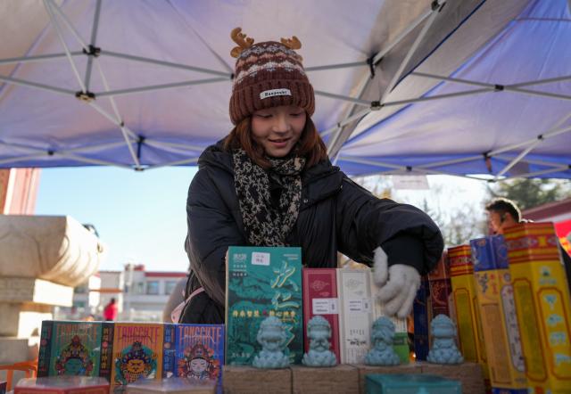 (251210) -- LHASA, Dec. 10, 2025 (Xinhua) -- A merchant arranges products during a supply and marketing fair at a park in Lhasa, southwest China's Xizang Autonomous Region, Dec. 10, 2025. The event has gathered more than 1,000 characteristic agricultural products from Xizang, including highland barley products, yak meat products, dairy products and so on, providing a platform for farmers and herdsmen to increase their income and people to purchase authentic specialties. (Xinhua/Jigme Dorje)