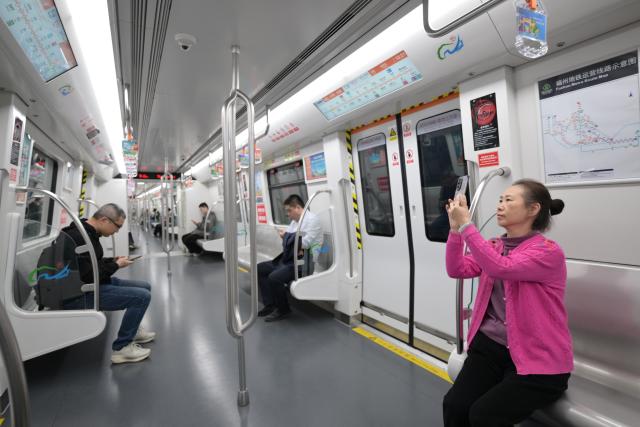 (251210) -- FUZHOU, Dec. 10, 2025 (Xinhua) -- Passengers are seen aboard a train of Fuzhou Metro Line 4 in Fuzhou City, southeast China's Fujian Province, Dec. 10, 2025. The Line 4 of Fuzhou Metro began operation on Wednesday. (Xinhua/Lin Shanchuan)