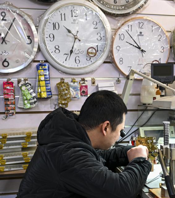 (251210) -- TIANJIN, Dec. 10, 2025 (Xinhua) -- A craftsman repairs a watch at a shop in the "repair alley" in north China's Tianjin, Dec. 9, 2025. A "repair alley" established in June 2024 has become a lively hub for neighborhood-friendly repair services in Tianjin. In this dedicated zone, local residents have easy access to daily services such as knife sharpening, darning, locksmiths and watch repair. (Xinhua/Xu Jiayi)