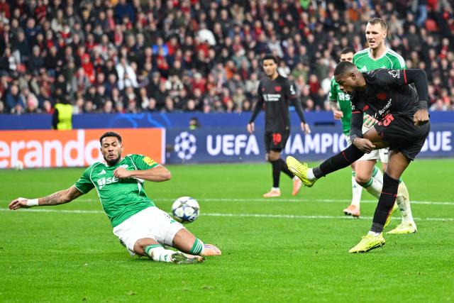 (251211) -- LEVERKUSEN, Dec. 11, 2025 (Xinhua) -- Christian Kofane (1st R) of Bayer 04 Leverkusen shoots during the UEFA Champions League football match between Bayer 04 Leverkusen and Newcastle United in Leverkusen, Germany,  Dec. 10, 2025. (Photo by Ulrich Hufnagel/Xinhua)