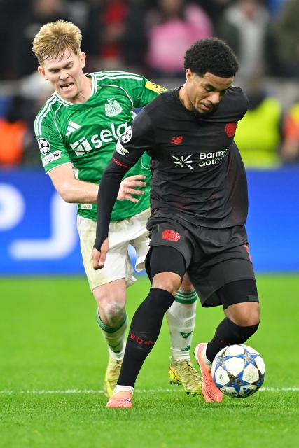 (251211) -- LEVERKUSEN, Dec. 11, 2025 (Xinhua) -- Malik Tillman (front) of Bayer 04 Leverkusen vies with Lewis Hall of Newcastle United during the UEFA Champions League football match between Bayer 04 Leverkusen and Newcastle United in Leverkusen, Germany,  Dec. 10, 2025. (Photo by Ulrich Hufnagel/Xinhua)