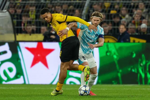 (251211) -- DORTMUND, Dec. 11, 2025 (Xinhua) -- Felix Nmecha (L) of Borussia Dortmund vies with Kasper Hogh of Bodo/Glimt during the UEFA Champions League football match between Borussia Dortmund and Bodo/Glimt in Dortmund, Germany, Dec. 10, 2025. (Photo by Joachim Bywaletz/Xinhua)