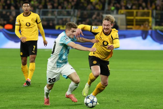 (251211) -- DORTMUND, Dec. 11, 2025 (Xinhua) -- Julian Brandt (R, front) of Borussia Dortmund vies with Fredrik Sjovold of Bodo/Glimt during the UEFA Champions League football match between Borussia Dortmund and Bodo/Glimt in Dortmund, Germany, Dec. 10, 2025. (Photo by Joachim Bywaletz/Xinhua)