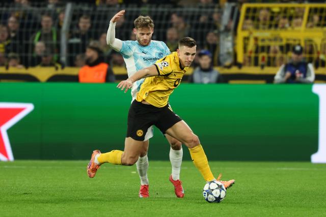 (251211) -- DORTMUND, Dec. 11, 2025 (Xinhua) -- Nico Schlotterbeck (front) of Borussia Dortmund vies with Ole Didrik Blomberg of Bodo/Glimt during the UEFA Champions League football match between Borussia Dortmund and Bodo/Glimt in Dortmund, Germany, Dec. 10, 2025. (Photo by Joachim Bywaletz/Xinhua)