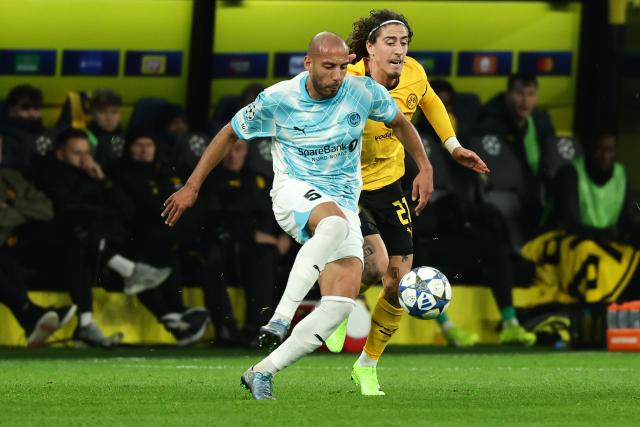 (251211) -- DORTMUND, Dec. 11, 2025 (Xinhua) -- Fabio Silva (rear) of Borussia Dortmund vies with Haitam Aleesami of Bodo/Glimt during the UEFA Champions League football match between Borussia Dortmund and Bodo/Glimt in Dortmund, Germany, Dec. 10, 2025. (Photo by Joachim Bywaletz/Xinhua)