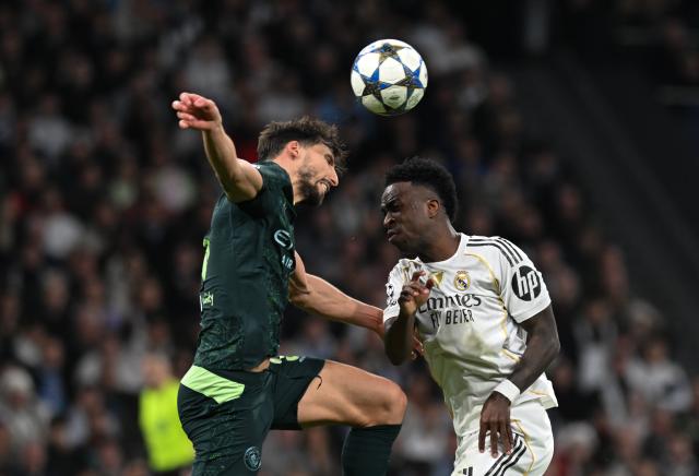 (251211) -- MADRID, Dec. 11, 2025 (Xinhua) -- Vinicius Junior (R) of Real Madrid heads for the ball during the UEFA Champions League football match between Real Madrid and Manchester City in Madrid, Spain, Dec. 10, 2025. (Xinhua/Cheng Min)