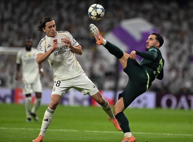 (251211) -- MADRID, Dec. 11, 2025 (Xinhua) -- Rayan Cherki (R) of Manchester City vies for the ball during the UEFA Champions League football match between Real Madrid and Manchester City in Madrid, Spain, Dec. 10, 2025. (Xinhua/Cheng Min)