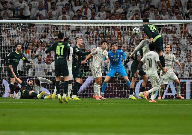 (251211) -- MADRID, Dec. 11, 2025 (Xinhua) -- Josko Gvardiol (2nd R) of Manchester City heads for the ball during the UEFA Champions League football match between Real Madrid and Manchester City in Madrid, Spain, Dec. 10, 2025. (Xinhua/Cheng Min)