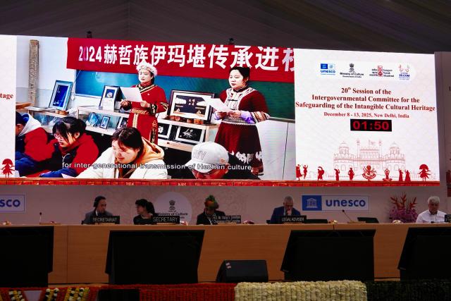 (251211) -- NEW DELHI, Dec. 11, 2025 (Xinhua) -- A video on the protection achievements of China's "Hezhen Yimakan storytelling" is played during the 20th regular session of the Intergovernmental Committee for the Safeguarding of the Intangible Cultural Heritage in New Delhi, India, Dec. 11, 2025. The Intergovernmental Committee for the Safeguarding of the Intangible Cultural Heritage at its 20th regular session decided to transfer China's "Hezhen Yimakan storytelling" from the List of Intangible Cultural Heritage in Need of Urgent Safeguarding to the Representative List of the Intangible Cultural Heritage of Humanity. 
   At the same time, based on the effectiveness of the protection of this heritage project, the committee decided to include the safeguarding program for Hezhen Yimakan storytelling in the Register of Good Safeguarding Practices. (Xinhua/Wu Yue)