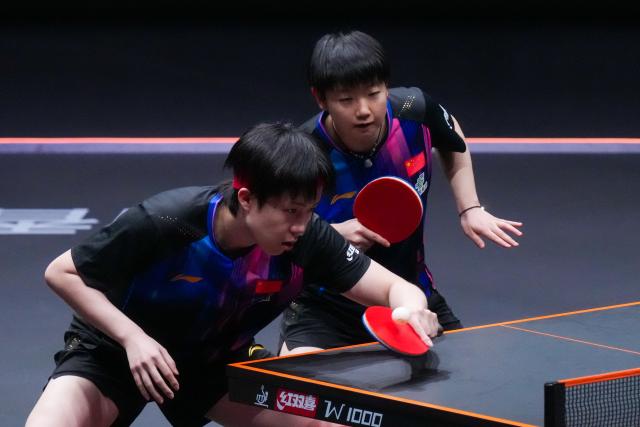 (251211) -- HONG KONG, Dec. 11, 2025 (Xinhua) -- Wang Chuqin (L)/Sun Yingsha compete during the mixed doubles group 1 match between Wang Chuqin/Sun Yingsha of China and Lin Shidong/Kuai Man of China at the WTT Finals Hong Kong 2025 in Hong Kong, south China, Dec. 11, 2025. (Xinhua/Zhu Wei)