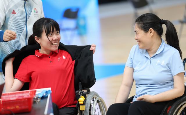 (251211) -- HONG KONG, Dec. 11, 2025 (Xinhua) -- Lin Ximei (L) of Guangdong reacts with Zhan Xia of Guangdong after the women's individual BC4 semifinals of boccia at China's 12th National Games for Persons with Disabilities and the 9th National Special Olympic Games in Hong Kong, south China, Dec. 11, 2025. (Xinhua/Lu Hanxin)