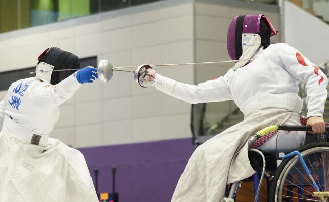 (251211) -- HONG KONG, Dec. 11, 2025 (Xinhua) -- Tan Shumei (R) of Shanghai competes against Ao Lanzhu of Shanghai during the women's epee individual category B final of wheelchair fencing at China's 12th National Games for Persons with Disabilities and the 9th National Special Olympic Games in Hong Kong, south China, Dec. 11, 2025. (Xinhua/Hou Jun)