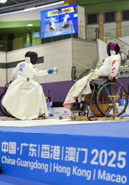(251211) -- HONG KONG, Dec. 11, 2025 (Xinhua) -- Tan Shumei (R) of Shanghai competes against Ao Lanzhu of Shanghai during the women's epee individual category B final of wheelchair fencing at China's 12th National Games for Persons with Disabilities and the 9th National Special Olympic Games in Hong Kong, south China, Dec. 11, 2025. (Xinhua/Hou Jun)