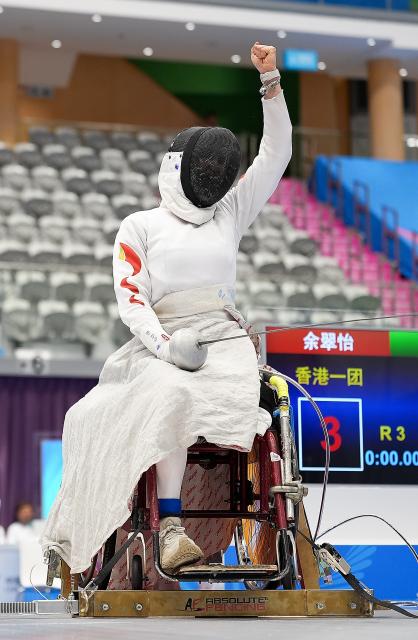 (251211) -- HONG KONG, Dec. 11, 2025 (Xinhua) -- Gu Haiyan of Shanghai celebrates during the women's epee individual category A final of wheelchair fencing at China's 12th National Games for Persons with Disabilities and the 9th National Special Olympic Games in Hong Kong, south China, Dec. 11, 2025. (Xinhua/Hou Zhaokang)