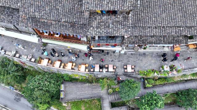 (251211) -- CHONGQING, Dec. 11, 2025 (Xinhua) -- An aerial drone photo taken on Dec. 11, 2025 shows tourists visiting the Gongtan Ancient Town in Youyang Tujia and Miao Autonomous County, southwest China's Chongqing Municipality. (Photo by Qiu Hongbin/Xinhua)