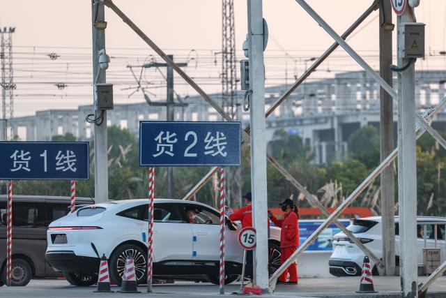 (251211) -- CHONGQING, Dec. 11, 2025 (Xinhua) -- Workers keep record of an export-bound new energy vehicle made in Chongqing at a commercial vehicle logistics base in Chongqing, southwest China, Nov. 29, 2025. In recent years, as Chongqing accelerated its transformation into an inland hub for opening-up, a growing number of locally manufactured vehicles have found their way to overseas markets. The local automotive industry encompasses a wide range of power solutions such as battery electric, plug-in hybrid, extended-range, hydrogen fuel cell and battery-swapping technologies. Evolving industrial chain, product quality and supply mechanisms have all contributed to Chongqing's growing vehicle exports. 
  According to the Chongqing Customs, in the first ten months of 2025, the export value of Chongqing-manufactured vehicles increased 13.6 percent year on year, reaching 40.22 billion yuan (about 5.70 billion U.S. dollars), with the export value of electric vehicles growing 72.1 percent year on year to reach 11.65 billion yuan (about 1.65 billion U.S. dollars). (Xinhua/Huang Wei)