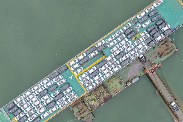 (251211) -- CHONGQING, Dec. 11, 2025 (Xinhua) -- A drone photo taken on Dec. 5, 2025 shows export-bound new energy vehicles being loaded onto a shipping vessel at a dock in Chongqing, southwest China. In recent years, as Chongqing accelerated its transformation into an inland hub for opening-up, a growing number of locally manufactured vehicles have found their way to overseas markets. The local automotive industry encompasses a wide range of power solutions such as battery electric, plug-in hybrid, extended-range, hydrogen fuel cell and battery-swapping technologies. Evolving industrial chain, product quality and supply mechanisms have all contributed to Chongqing's growing vehicle exports. 
  According to the Chongqing Customs, in the first ten months of 2025, the export value of Chongqing-manufactured vehicles increased 13.6 percent year on year, reaching 40.22 billion yuan (about 5.70 billion U.S. dollars), with the export value of electric vehicles growing 72.1 percent year on year to reach 11.65 billion yuan (about 1.65 billion U.S. dollars). (Xinhua/Huang Wei)