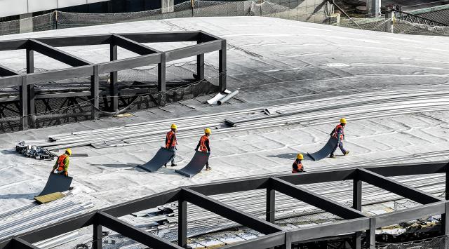 (251211) -- LIUPANSHUI, Dec. 11, 2025 (Xinhua) -- A drone photo taken on Dec. 11, 2025 shows workers at a construction site of the Liupanshui Railway Station building and yard renovation project in Liupanshui City, southwest China's Guizhou Province. The renovation project of the station building and yard of Liupanshui Railway Station on the Anshun-Liupanshui High-Speed Railway is advancing steadily at present. (Xinhua/Tao Liang)