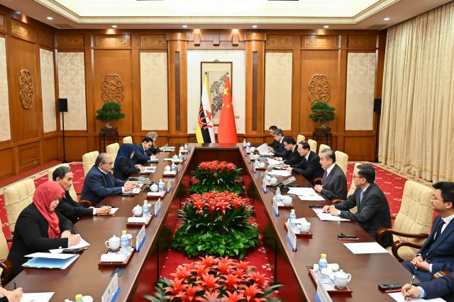 (251211) -- BEIJING, Dec. 11, 2025 (Xinhua) -- Chinese Foreign Minister Wang Yi, also a member of the Political Bureau of the Communist Party of China Central Committee, holds talks with Dato Erywan Pehin Yusof, Brunei's second minister of foreign affairs, in Beijing, capital of China, Dec. 11, 2025. (Xinhua/Li Xin)