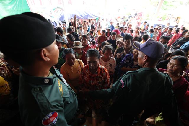 (251211) -- SIEM REAP, Dec. 11, 2025 (Xinhua) -- Cambodian evacuees wait for relief items distribution at a safe zone in Siem Reap province, Cambodia, on Dec. 11, 2025. At least 10 Cambodian civilians have been killed and 60 others wounded in the latest round of border conflict with Thailand, a Cambodian Defense Spokesperson said on Thursday. (Photo by Sovannara/Xinhua)