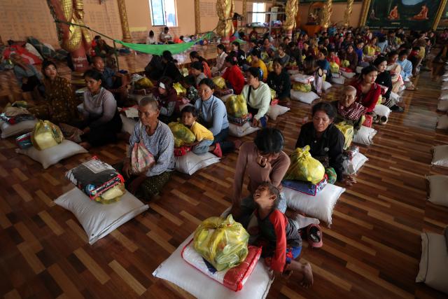(251211) -- SIEM REAP, Dec. 11, 2025 (Xinhua) -- Cambodian evacuees receive relief items at a safe zone in Siem Reap province, Cambodia, on Dec. 11, 2025. At least 10 Cambodian civilians have been killed and 60 others wounded in the latest round of border conflict with Thailand, a Cambodian Defense Spokesperson said on Thursday. (Photo by Sovannara/Xinhua)